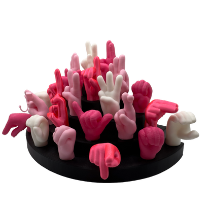 Set of pink, magnet and white hand gesture figures on a black base